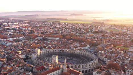 Arles-unreal-aerial-shot-sunrise-mountains-and-foggy-field-amphitheater-France